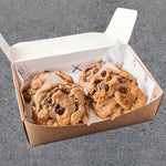 Four delicious Blake's Brown Butter Double Chocolate Chip Cookies on a plate, showcasing their rich chocolatey texture.